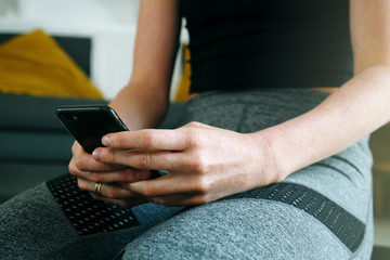 Phone online fitness class fit woman using mobile app at home