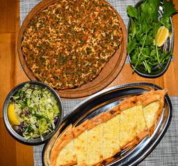 Traditional Turkish pizza, called Lahmacun, being prepared with meat, onion and parsley