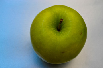 green apple on a blue background