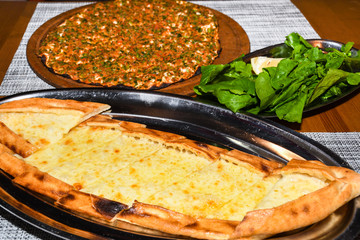 Traditional Turkish pizza, called Lahmacun, being prepared with meat, onion and parsley