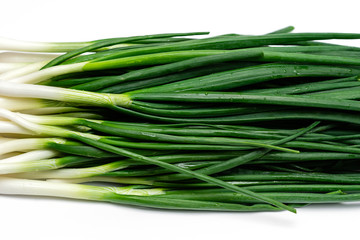 bunch of green fresh onions on a white background