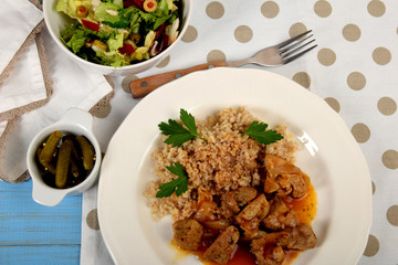 barley and pieces of fried meat with onions, goulash