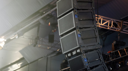 Professional audio equipment suspended from the ceiling. Audio speakers for events