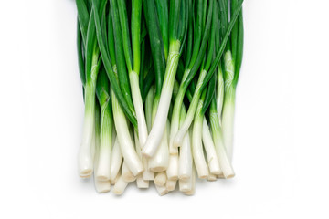 bunch of green fresh onions on a white background