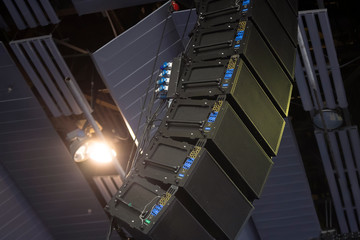 Professional audio equipment suspended from the ceiling. Audio speakers for events