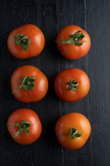 tomatoes on dark wood table