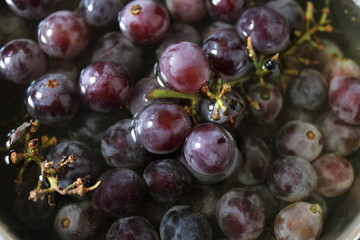 Black grapes in water,wash it before having.