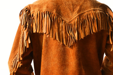 An image of an old vintage style leather coat with long fringes. 