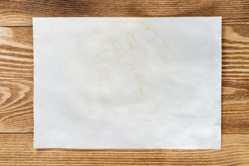 Flat lay wooden table with paper sheet