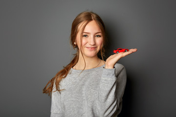 Young, authentic and beautiful woman is happy about her first car, idea and concept for beginner...