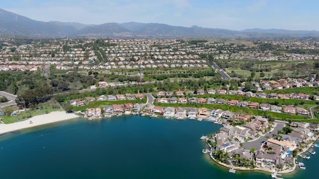 Aerial view of Lake Mission Viejo, with recreational facilities, surrounded by private residential and condominium communities. Orange County, California, USA