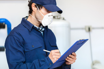 Plumber at work wearing a mask, coronavirus concept