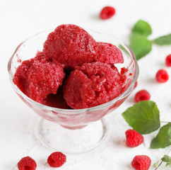 homemade ice cream raspberry sorbet in kremanke and fresh raspberries on a light background. square format