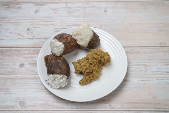 Glutinous rice steamed cooked with coconut milk in pitcher plants known as lemang periuk kera with spicy chicken rendang. A traditional malay cuisine during Hari Raya festival.