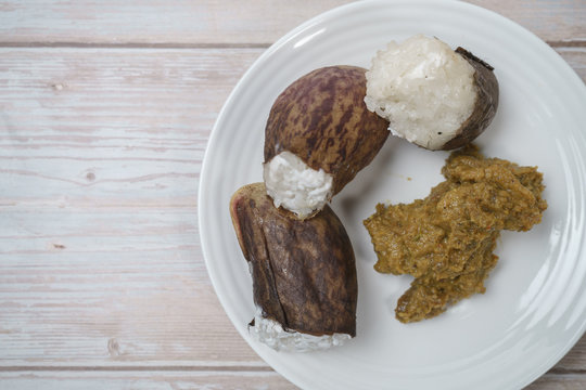 Glutinous Rice Steamed Cooked With Coconut Milk In Pitcher Plants Known As Lemang Periuk Kera With Spicy Chicken Rendang. A Traditional Malay Cuisine During Hari Raya Festival.