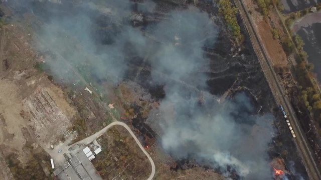 Aerial view of wildfire, spreading flames of forest fire. Natural disaster due to extreme heat and climate change
