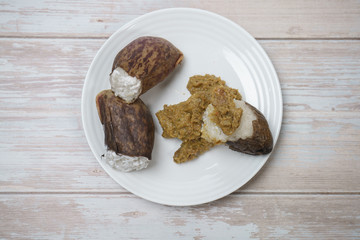 Glutinous rice steamed cooked with coconut milk in pitcher plants known as lemang periuk kera with spicy chicken rendang. A traditional malay cuisine during Hari Raya festival.