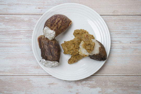 Glutinous rice steamed cooked with coconut milk in pitcher plants known as lemang periuk kera with spicy chicken rendang. A traditional malay cuisine during Hari Raya festival.
