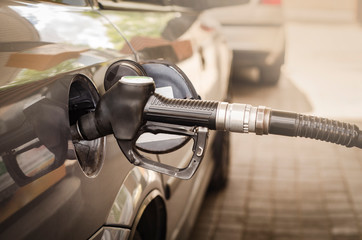 Car refueling on the petrol station. Hand refilling the car with fuel 
gasoline. 