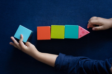 kid organizing color blocks