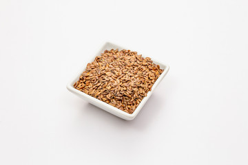 Brown flax seeds isolated on white background