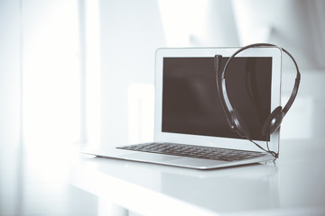 Call center and communication support, customer service help desk. VOIP headset on laptop computer