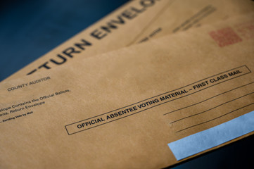 Selective focus on brown official absentee ballot voting material envelope