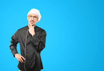 Concerned young chef making a gesture of doubt