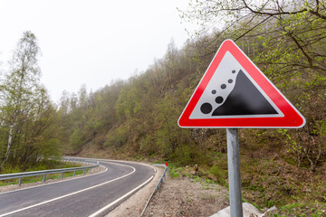 Warning sign "rockfall possible". Mountain road