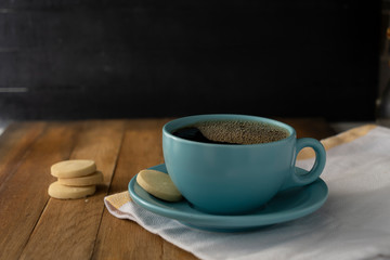 blue cup of coffee with cookies