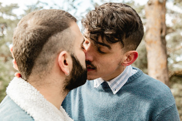 Gay couple in love at the forest