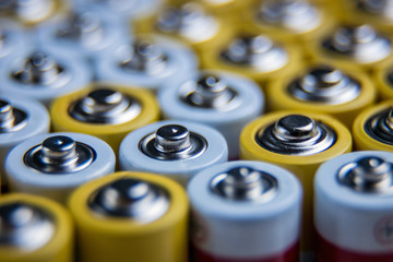 The batteries stand close together and form a beautiful background. Selective focus. Artistic...