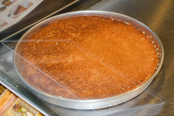 Turkish dessert kunefe with pistachio powder. Kunafa, kadayif with pistachio powder and cheese hot