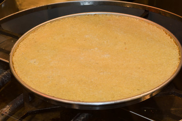 Turkish dessert kunefe with pistachio powder. Kunafa, kadayif with pistachio powder and cheese hot