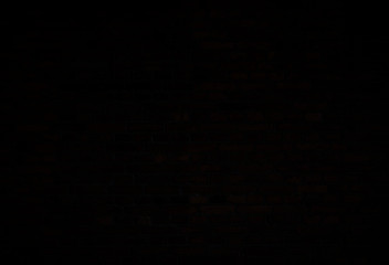 Dark, almost black, old red brick wall. Full frame textured background. Copy space.