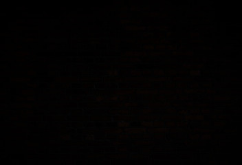 Dark, almost black, old red brick wall. Full frame textured background. Copy space.