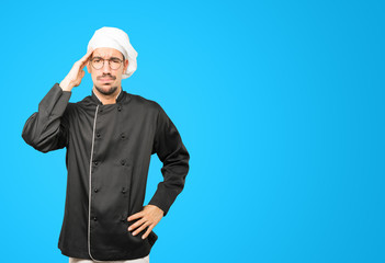 Concerned young chef with a stress gesture