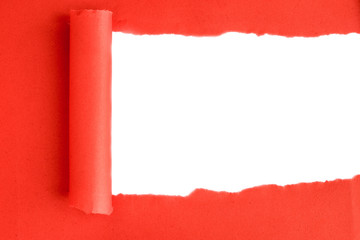 Ripped red cardboard with space for text. Torn paper roll with opening showing white background