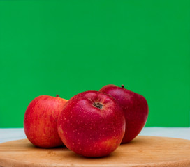 Red apples on a green background. Fruits. Harvest 2020, detox.