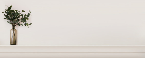 The concept of a bright and cozy interior in Scandinavian style with decorative details and a white wall