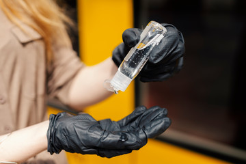 Woman wearing white protective face mask is using public transportation during the epidemic outbreak