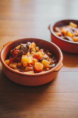 potatoes and meat stew on a clay container