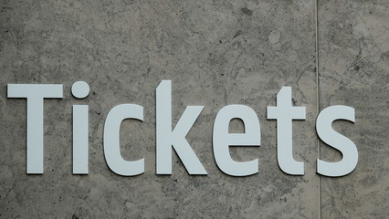 Word Tickets at wall is grey in color. Close up