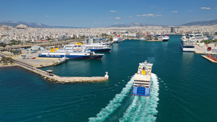 Aerial drone photo of passenger ferry reaching destination - busy port of Piraeus, Attica, Greece