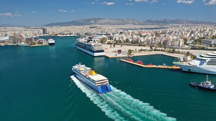 Fototapeta na wymiar Aerial drone photo of passenger ferry reaching destination - busy port of Piraeus, Attica, Greece
