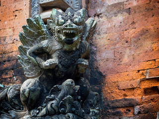 Fototapeta na wymiar Balinese mythological demon statue at ancient Monkey Forest temple in Ubud, Bali, Indonesia.