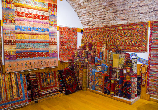 Pile of beautiful handmade carpets on the open market bazaar. Turkish traditional design.