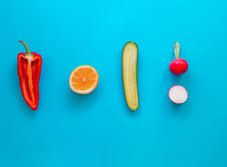 Flat lay top view of fresh vegetables over pastel blue backdrop with minimal style, copy space