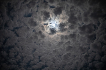 Cloudy sky with the moon in the center - 347265886
