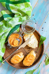 Snack or breakfast. Sandwiches with butter and salted caviar on a wooden kitchen table. Top view flat lay background. Copy space.